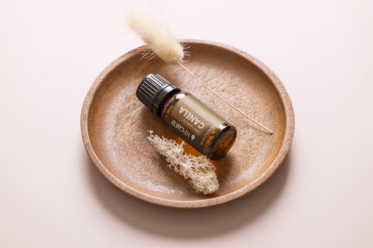a small bottle of essential oils sitting on a plate