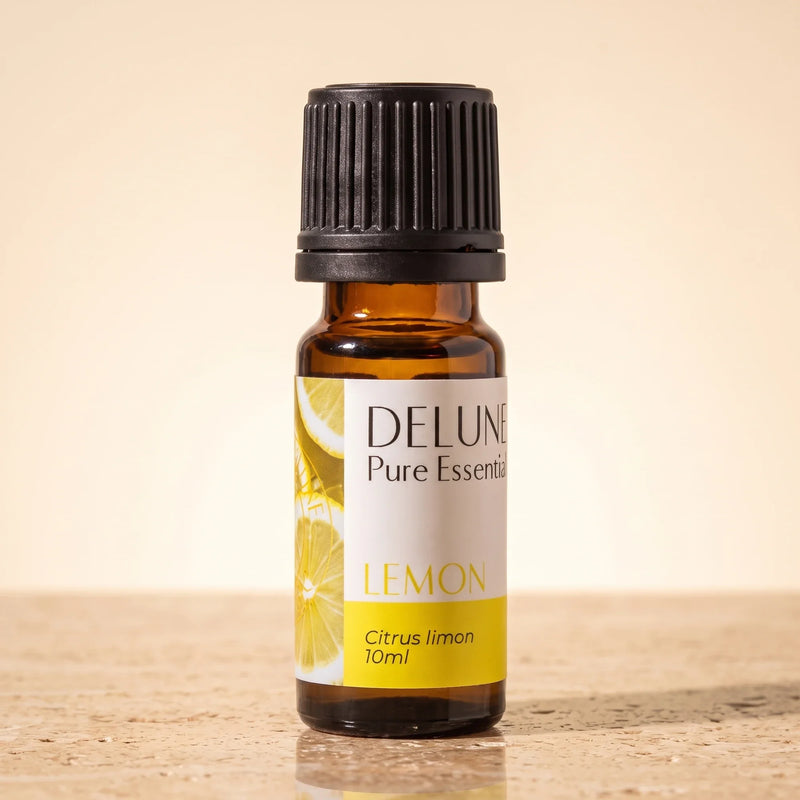 Óleo essencial puro de limão Delune, frasco âmbar de 10 ml sobre travertino quente