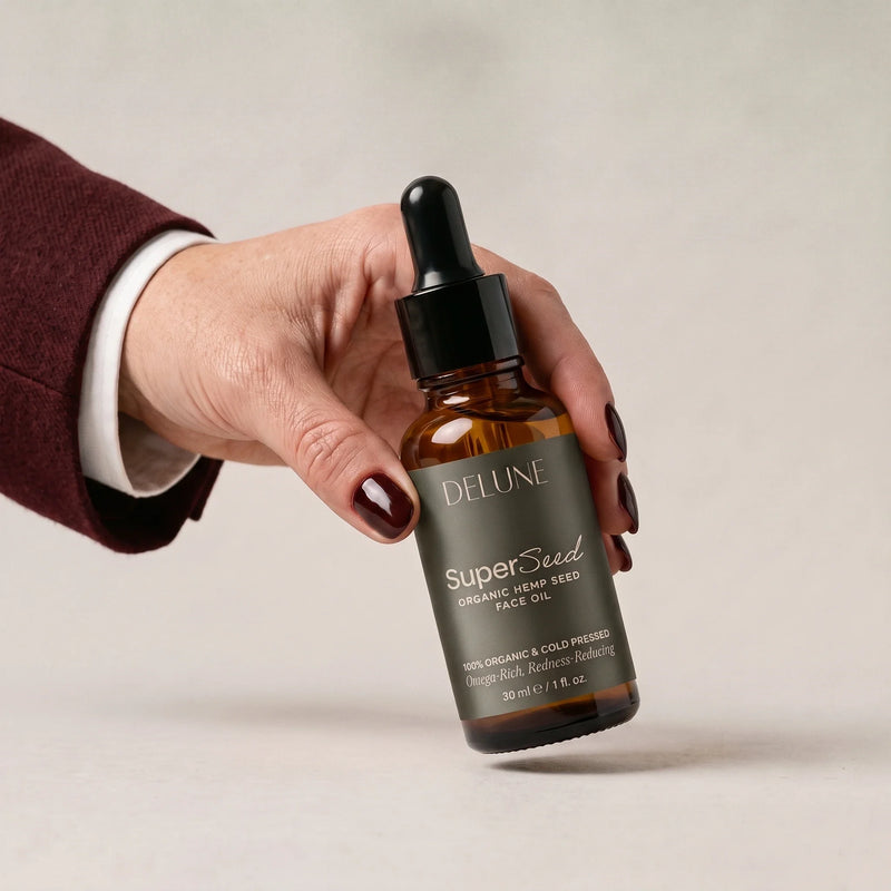 Mão pegando o óleo facial Super Seed Delune